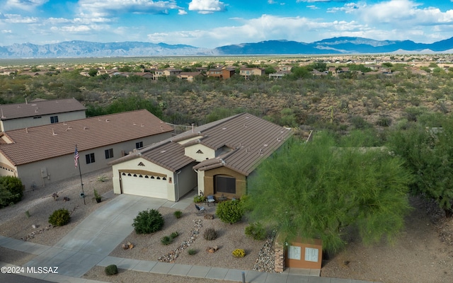 birds eye view of property with a mountain view