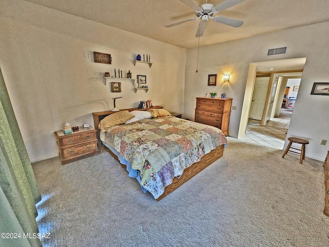 bedroom with visible vents, ceiling fan, and carpet