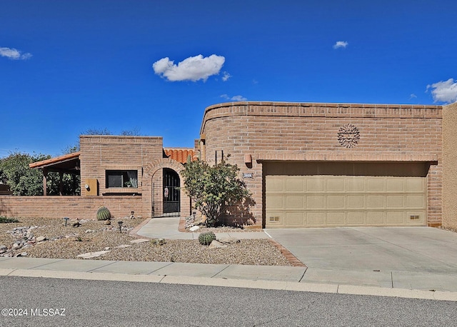 view of front of home featuring concrete driveway, brick siding, and a garage