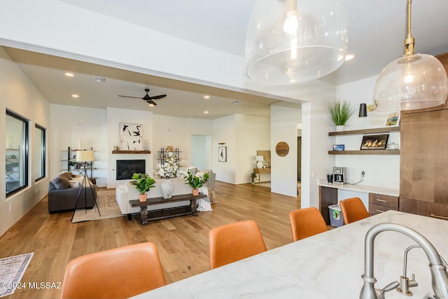 dining area featuring ceiling fan and light wood-type flooring