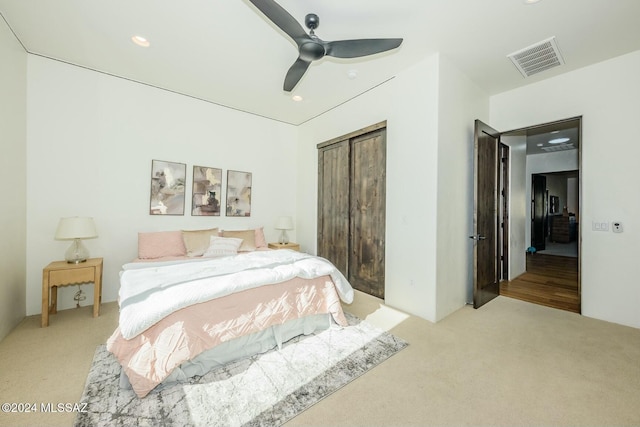 bedroom with ceiling fan and light carpet