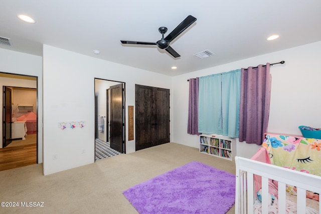 bedroom with ceiling fan and light colored carpet