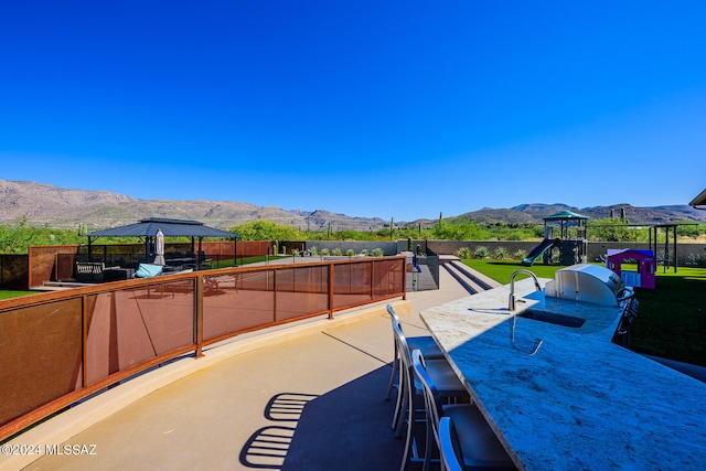 view of patio / terrace with a mountain view and a gazebo