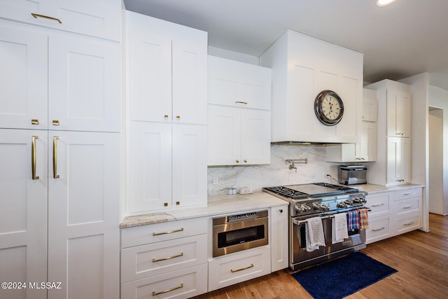 kitchen featuring white cabinetry, light wood-type flooring, and stainless steel appliances