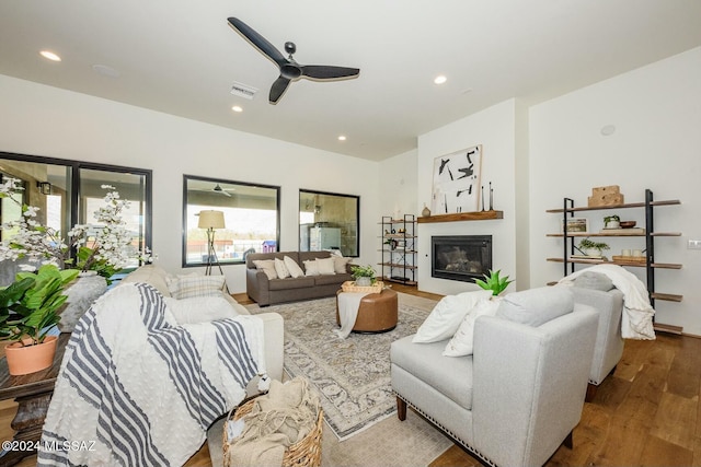 living room with hardwood / wood-style flooring and ceiling fan