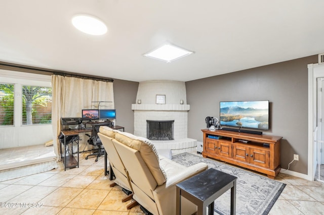 living room featuring a fireplace and light tile patterned flooring