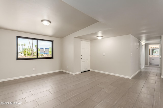 spare room with vaulted ceiling