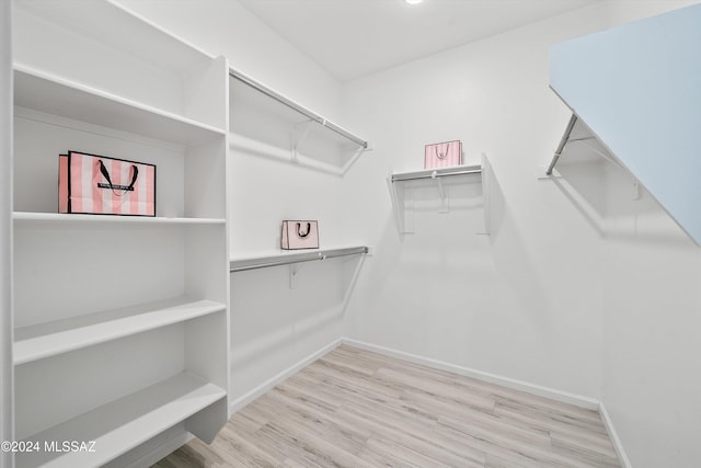 spacious closet with light hardwood / wood-style floors