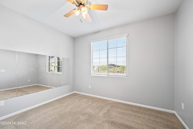 carpeted empty room with ceiling fan