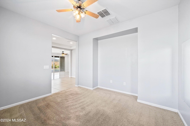 unfurnished room with light carpet and ceiling fan