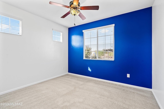 carpeted empty room featuring ceiling fan