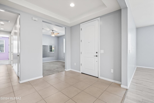 tiled entryway featuring ceiling fan