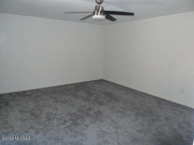 carpeted empty room with ceiling fan