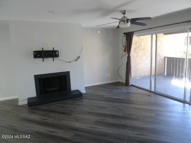 unfurnished living room featuring ceiling fan and dark hardwood / wood-style floors