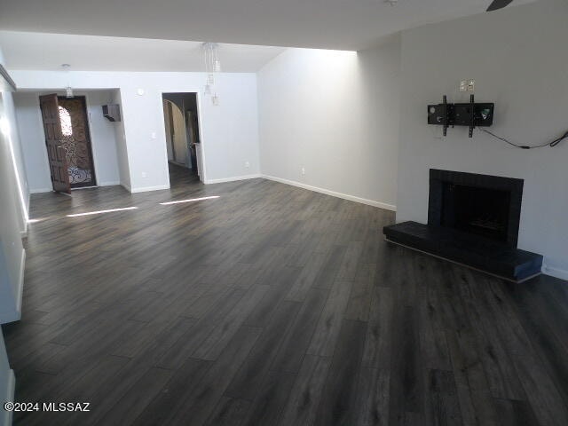 unfurnished living room featuring dark hardwood / wood-style floors