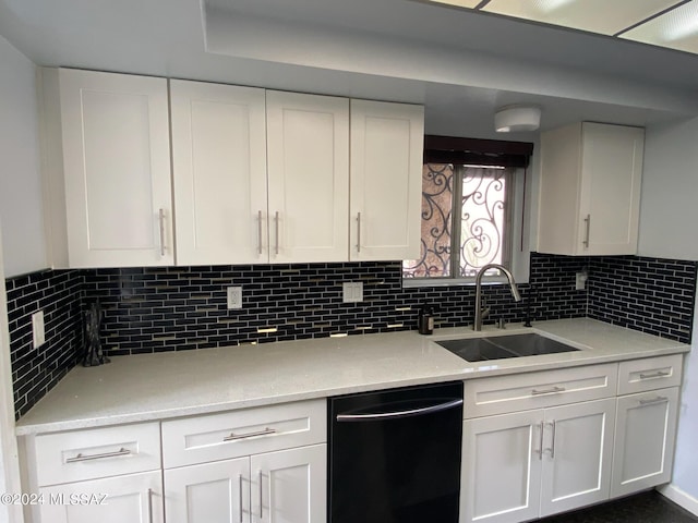 kitchen featuring light stone countertops, decorative backsplash, white cabinets, sink, and black dishwasher