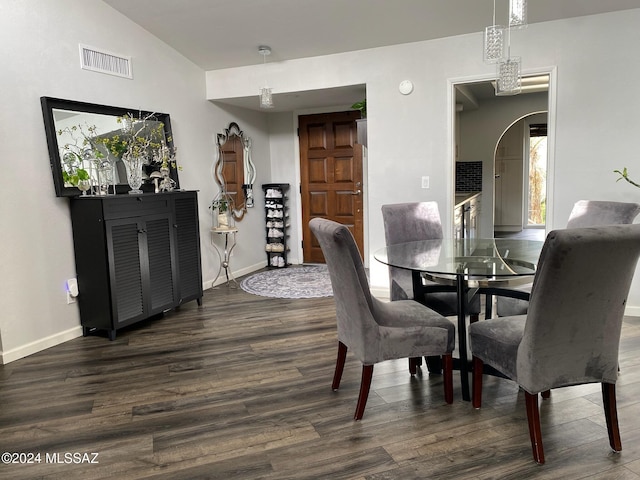 dining space with lofted ceiling and dark wood-type flooring