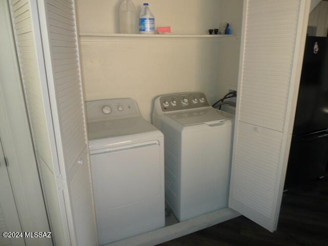 washroom featuring separate washer and dryer and dark hardwood / wood-style flooring