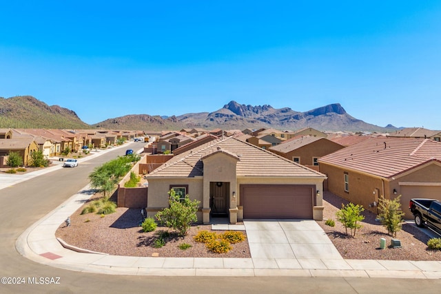 view of front of home with a mountain view and a garage