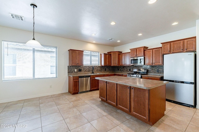 kitchen featuring sink, a center island, stainless steel appliances, decorative light fixtures, and light tile patterned floors