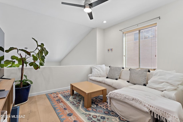 living room with vaulted ceiling, hardwood / wood-style flooring, and ceiling fan