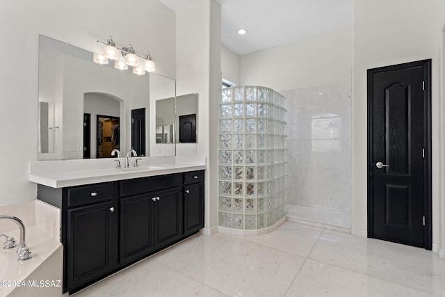 bathroom with vanity, tile patterned flooring, and a tile shower