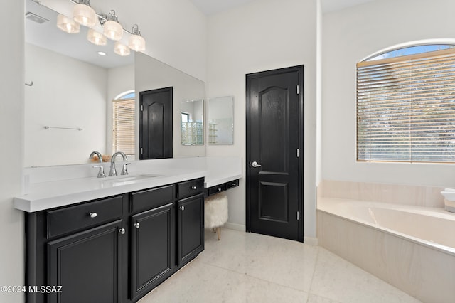 bathroom with vanity and a tub