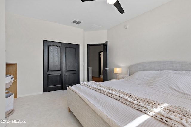 carpeted bedroom featuring ceiling fan and a closet