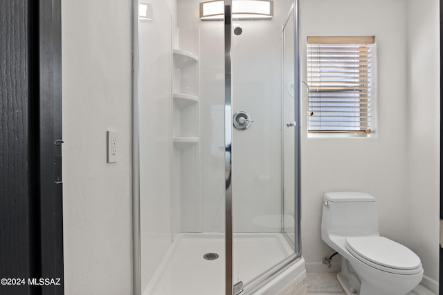 bathroom featuring tile patterned flooring, walk in shower, and toilet