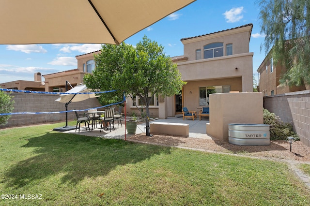 back of property featuring a patio and a lawn