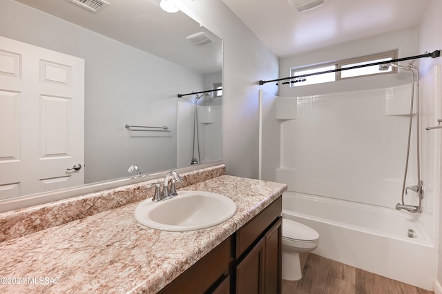 full bathroom with vanity, toilet, wood-type flooring, and tub / shower combination