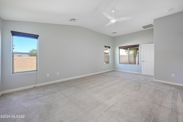 unfurnished room featuring vaulted ceiling, carpet floors, and ceiling fan