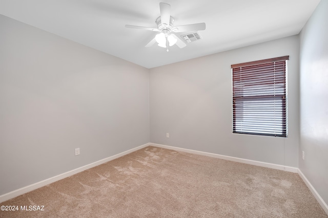 empty room with light carpet and ceiling fan