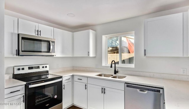 kitchen featuring white cabinetry, stainless steel appliances, and sink