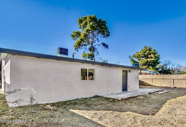 1738 N Cloverland Ave, Tucson, AZ 85712 - back of house with stucco siding, cooling unit, and a patio