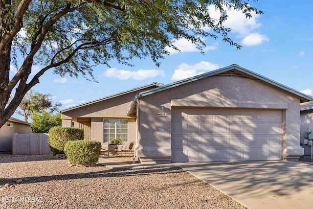 ranch-style home featuring a garage