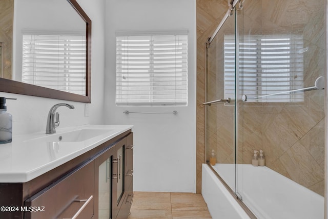 bathroom with tile patterned floors, bath / shower combo with glass door, and vanity