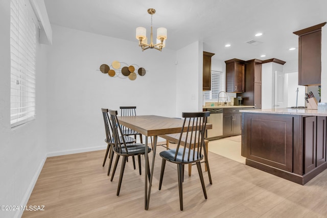 dining space featuring a chandelier and light hardwood / wood-style floors