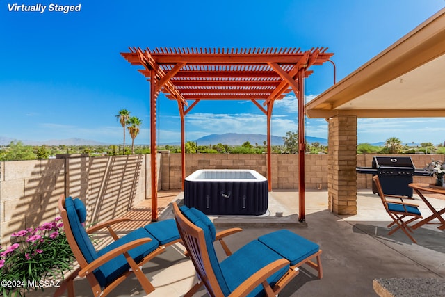 view of patio / terrace with a grill, a pergola, and a mountain view