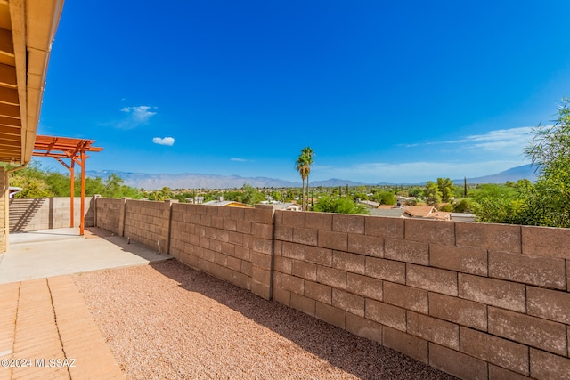 view of yard featuring a mountain view and a patio area