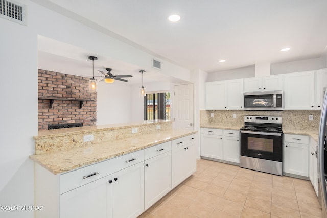 kitchen featuring decorative backsplash, stainless steel appliances, white cabinetry, decorative light fixtures, and light tile patterned floors