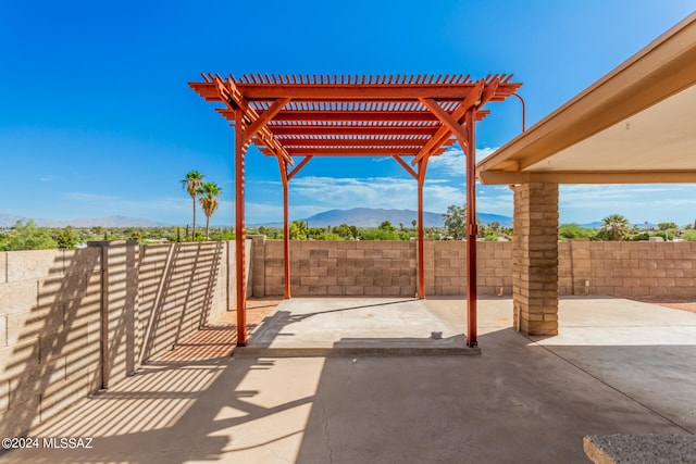 view of patio / terrace featuring a mountain view and a pergola