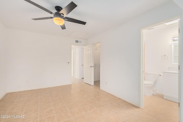 spare room featuring ceiling fan and light tile patterned floors