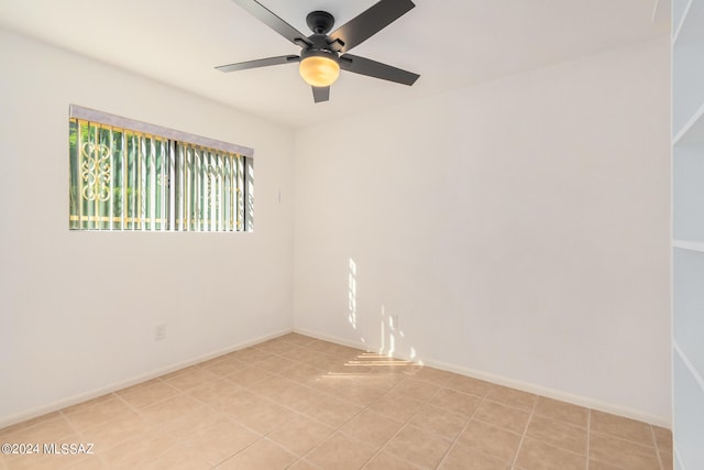 tiled empty room with ceiling fan