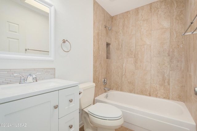 full bathroom featuring tiled shower / bath, vanity, toilet, and decorative backsplash