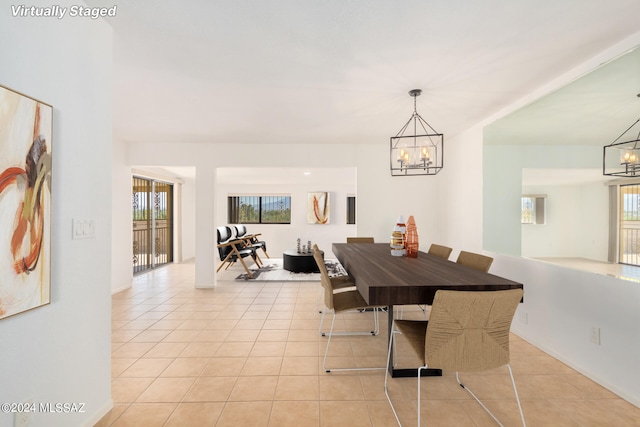 tiled dining area with a notable chandelier