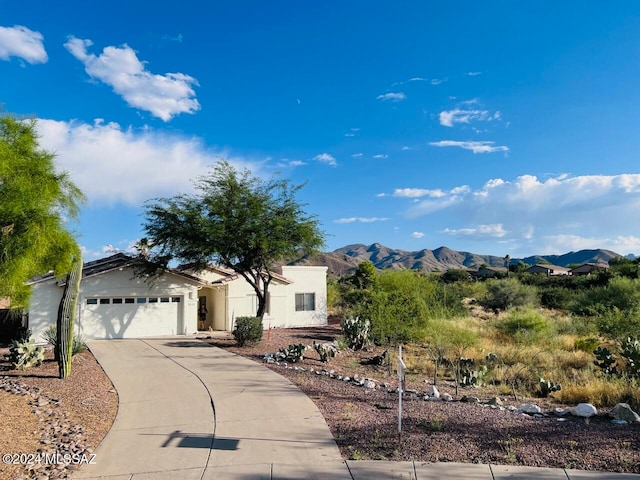 view of front of property with a garage and a mountain view