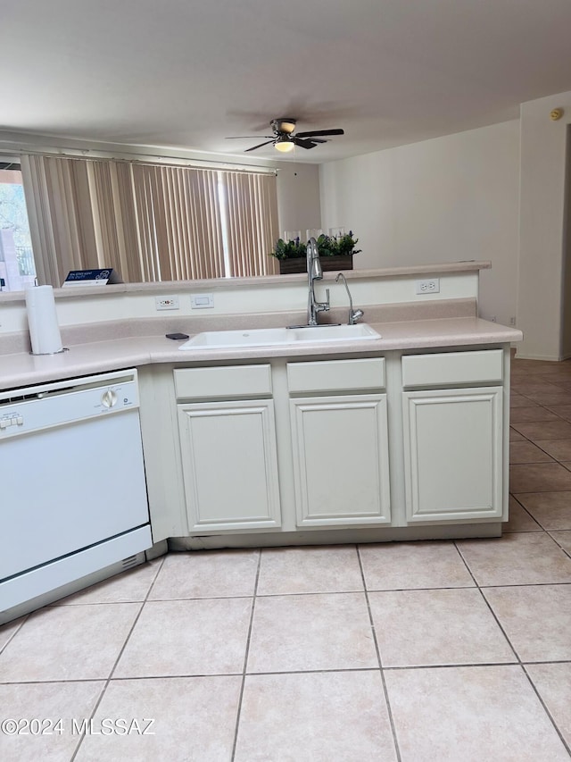 kitchen with light tile patterned floors, a ceiling fan, white dishwasher, light countertops, and a sink