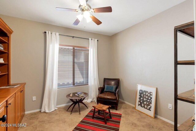 living area featuring ceiling fan