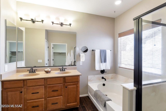 bathroom with vanity, hardwood / wood-style flooring, and separate shower and tub